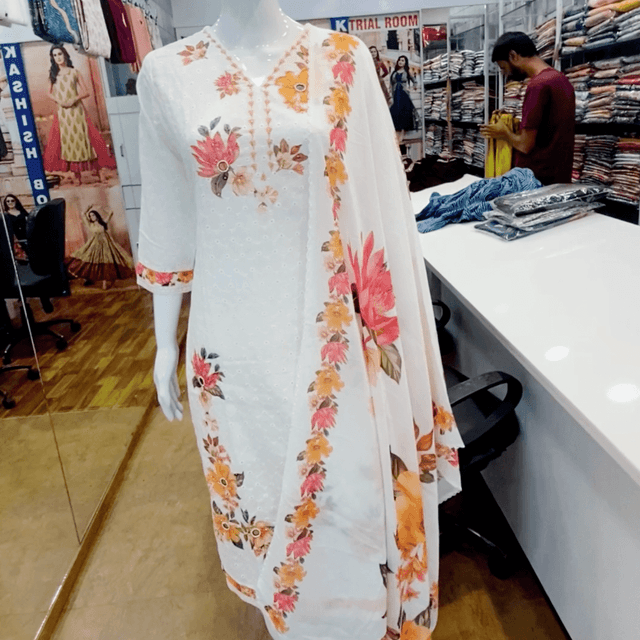 White, with floral patterns in shades of pink, orange, and yellow Salwar Kameez