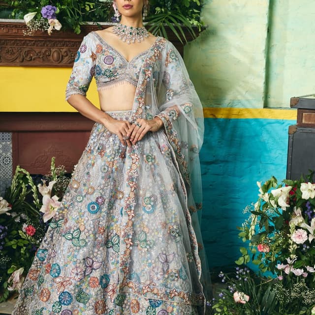 Soft blues, greens, oranges, and pinks on a light blue base Lehenga Choli