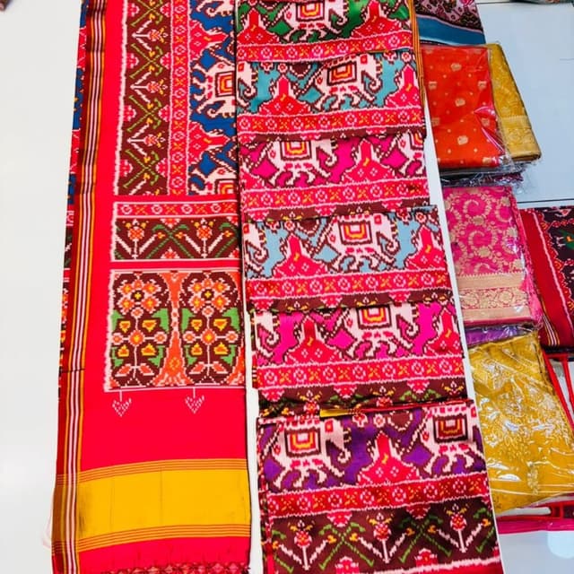 Multicolor with dominant shades of pink, red, blue, yellow, purple, and green Saree and possibly fabric for a blouse or suit